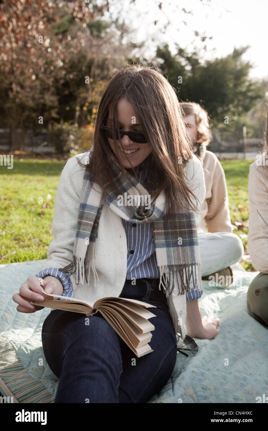 Girl reading book in park Stock Photo