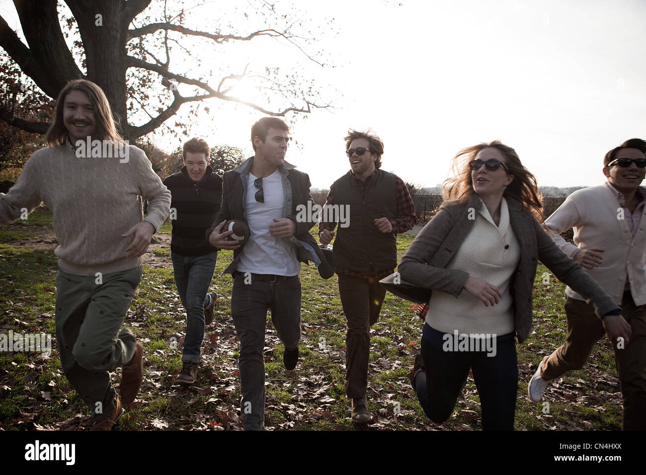 Group of friends running in park Stock Photo