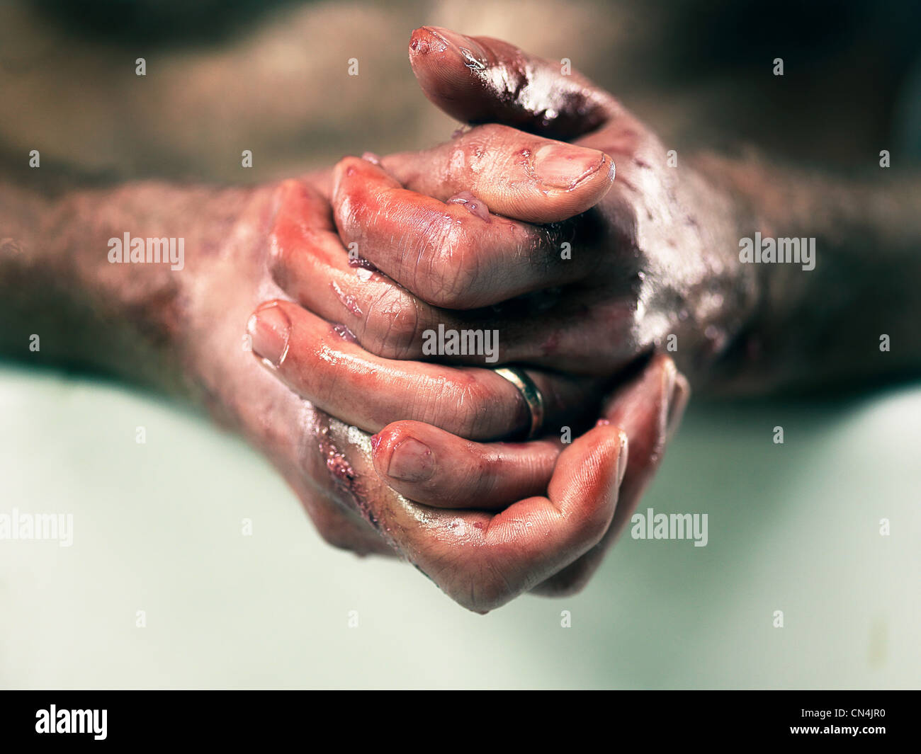 Fishmonger washing bloodied hands Stock Photo