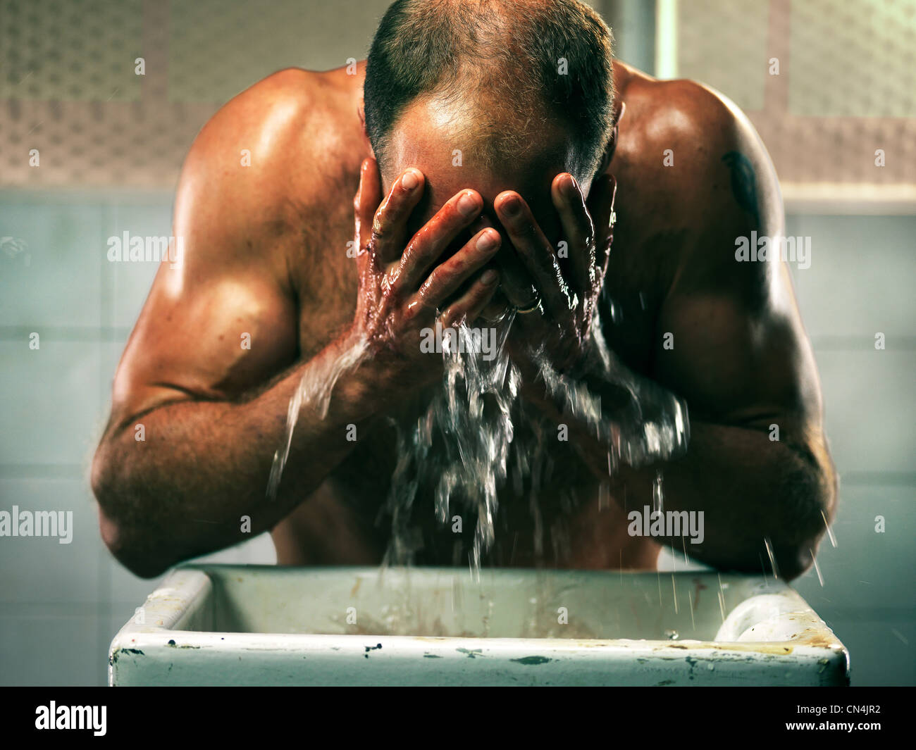 Fishmonger washing face in sink Stock Photo Alamy