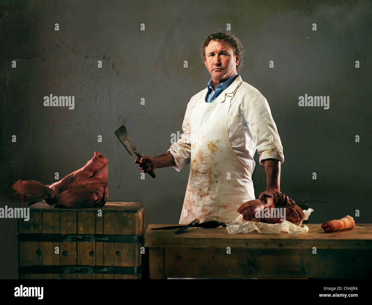 Butcher preparing meat from pig Stock Photo