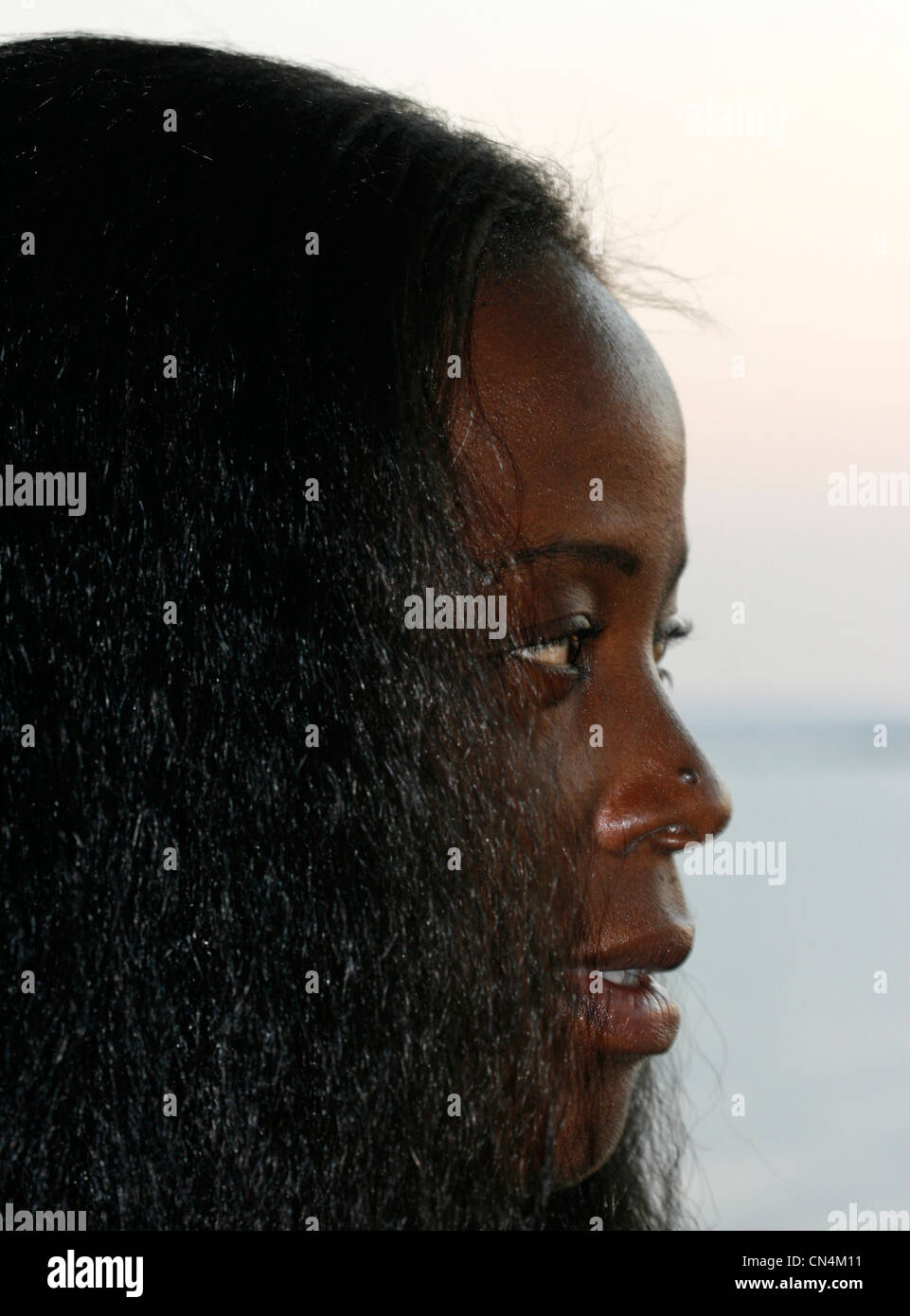 A young African woman looking thoughtful Stock Photo