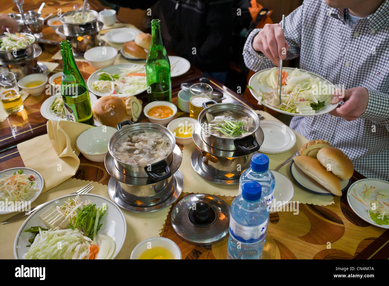 North Korea, Pyongyang, boiled meat buffet on the table of a tourist