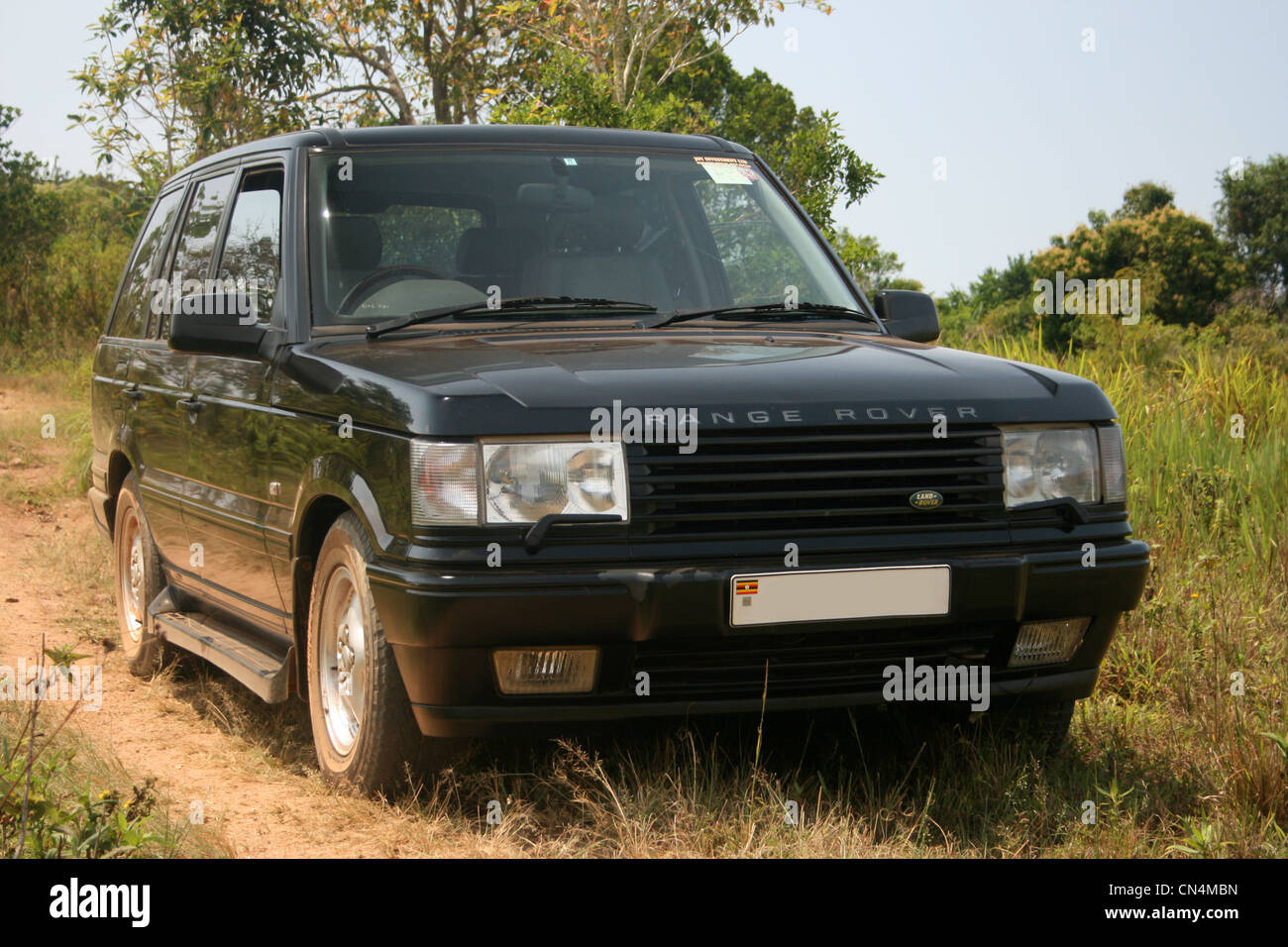 Range Rover on a murram track in the bush, Uganda Stock Photo