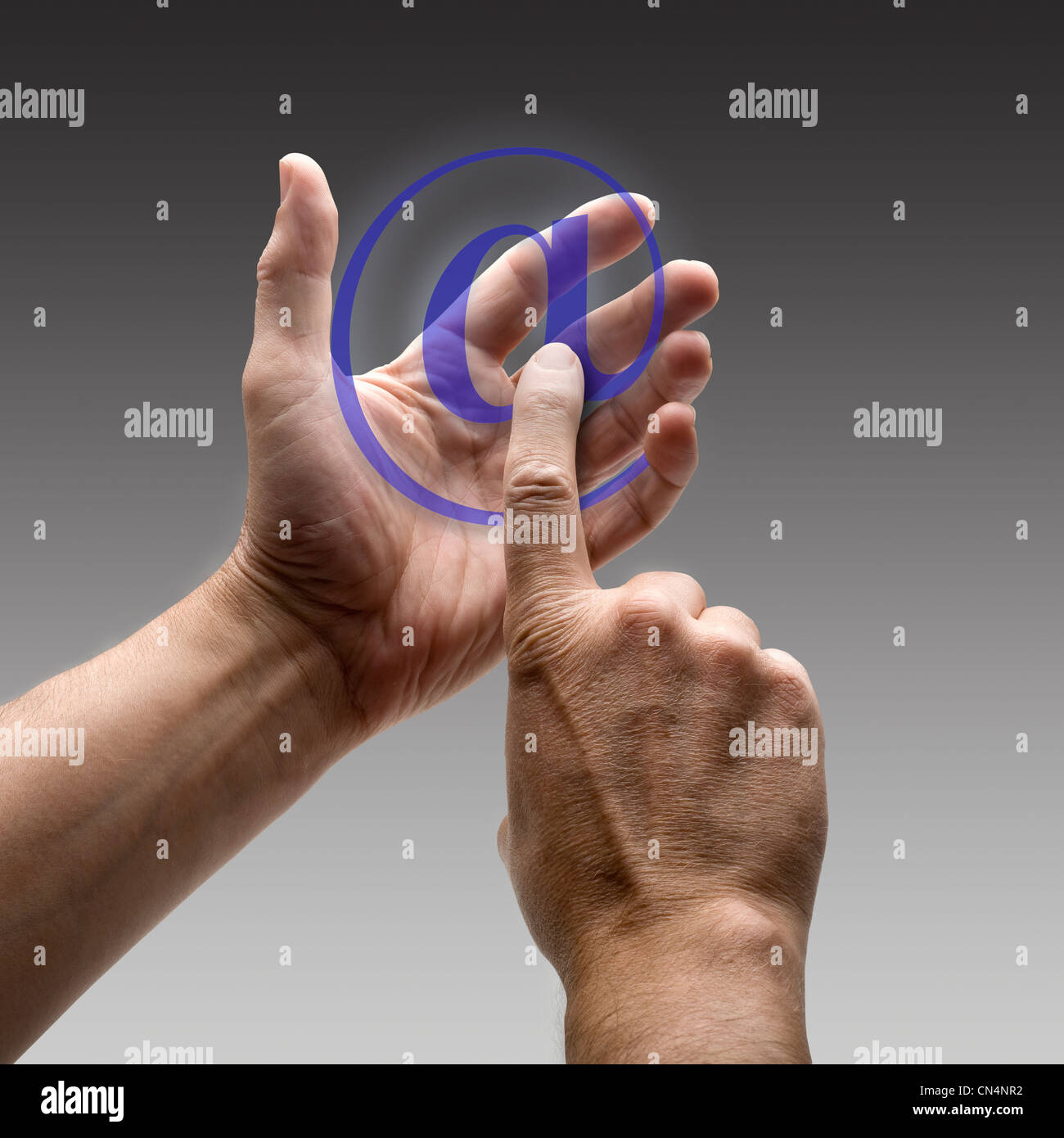 Two hands holding a at symbol. There is a route for hand and finger ...