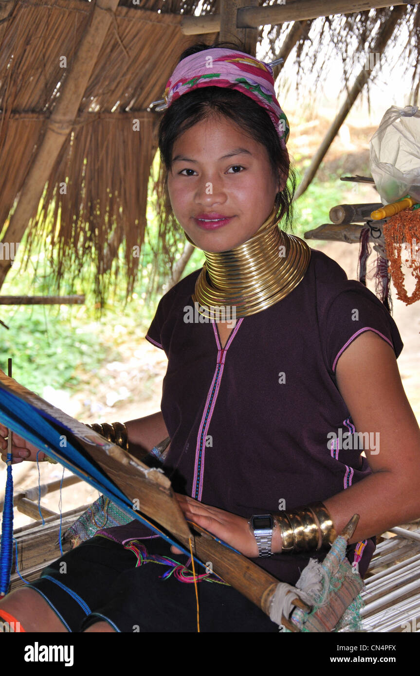 A young Kayan Lahwi girl weaving at Karen Long Neck hill tribe village, Chiang Rai Province, Thailand Stock Photo