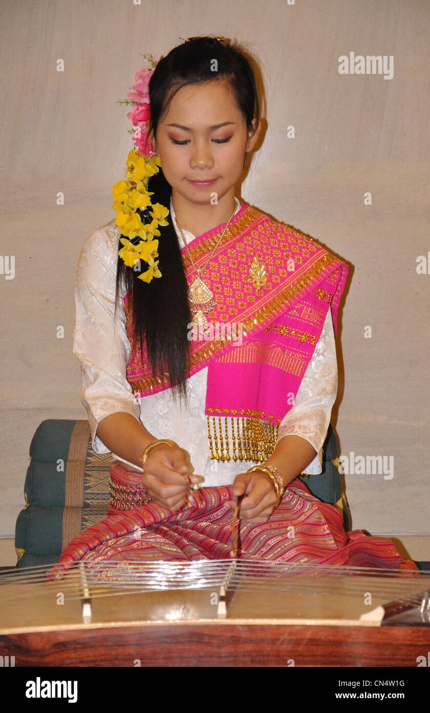 Woman playing string instrument in The Imperial Mae Ping Hotel, Sridonchai Road, Chang Klan, Chiang Mai, Chiang Mai, Thailand Stock Photo