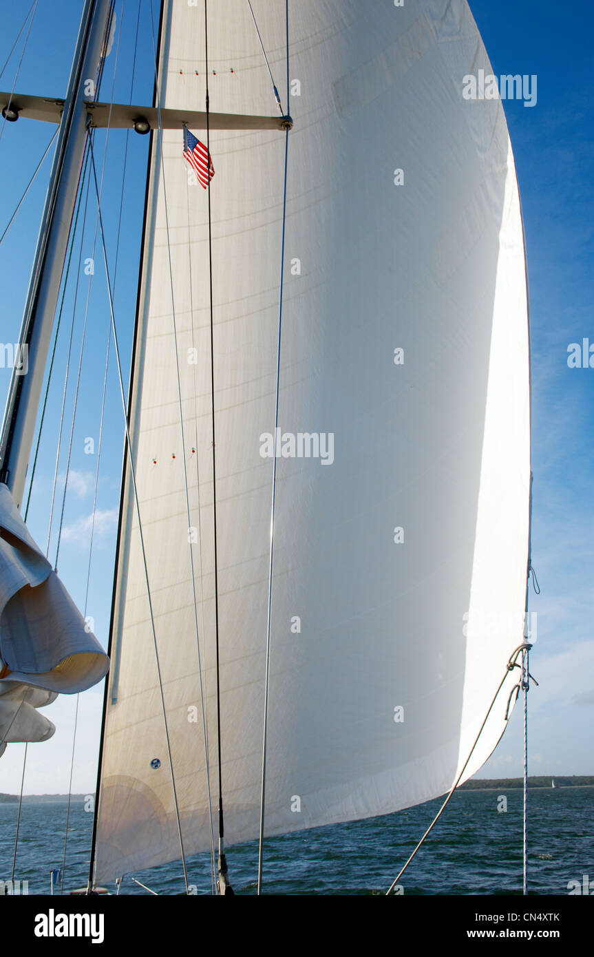 Sail of yacht with USA flag. White Sail. Sailing. America flag Stock Photo