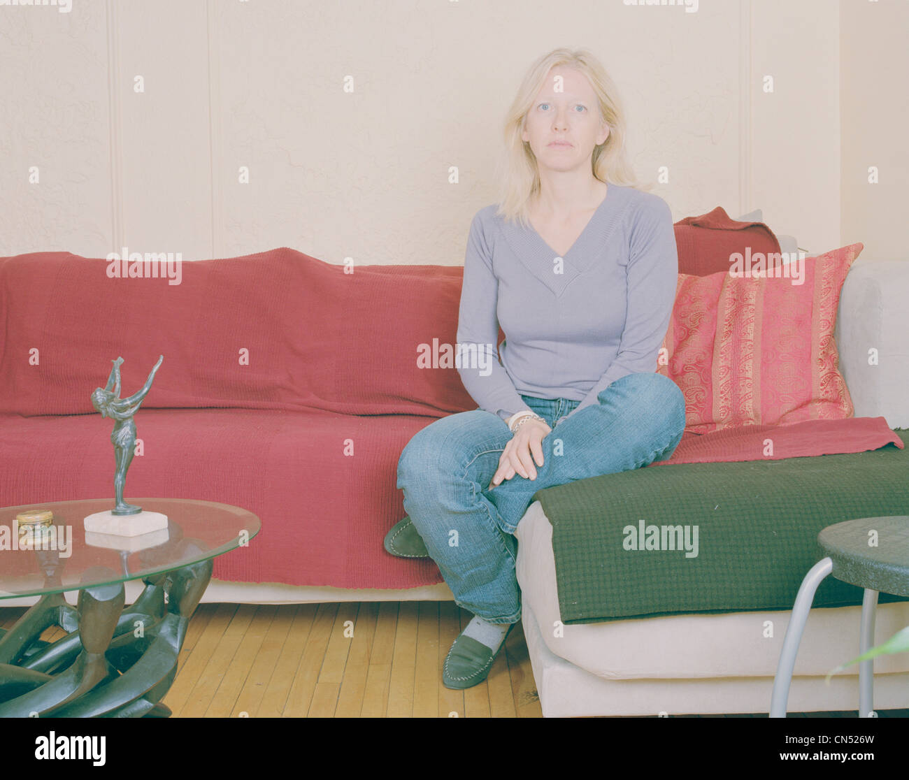 Portrait of a Woman Sitting on a Couch, Montreal, Quebec Stock Photo