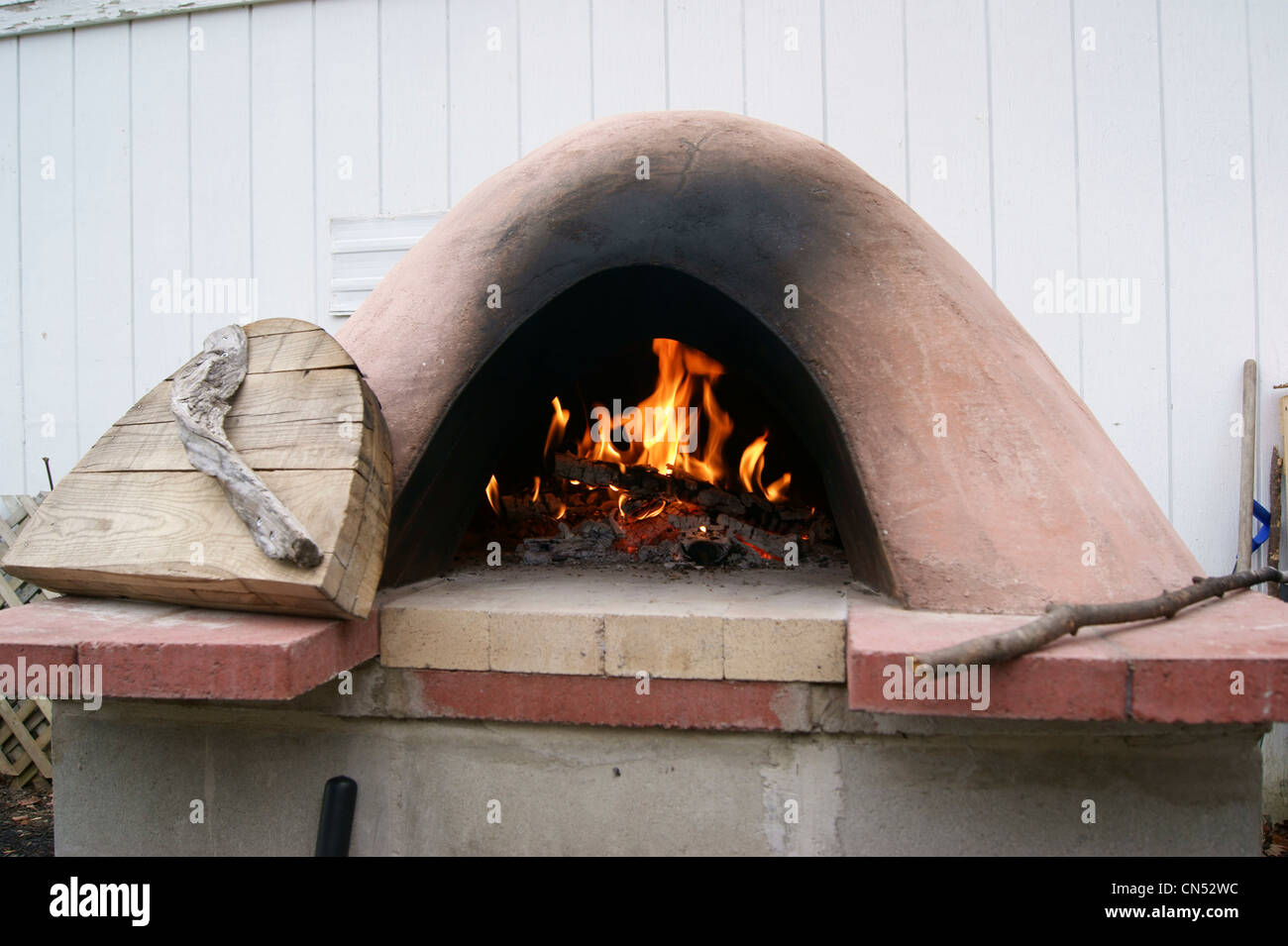 Adobe oven with wood fire, East Vassalboro, Maine. Stock Photo