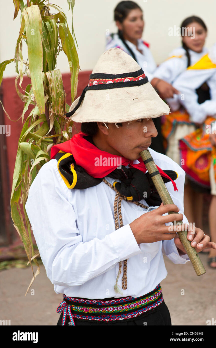 Peru, Cuzco Province, Huaro, young playing flute in traditional dress