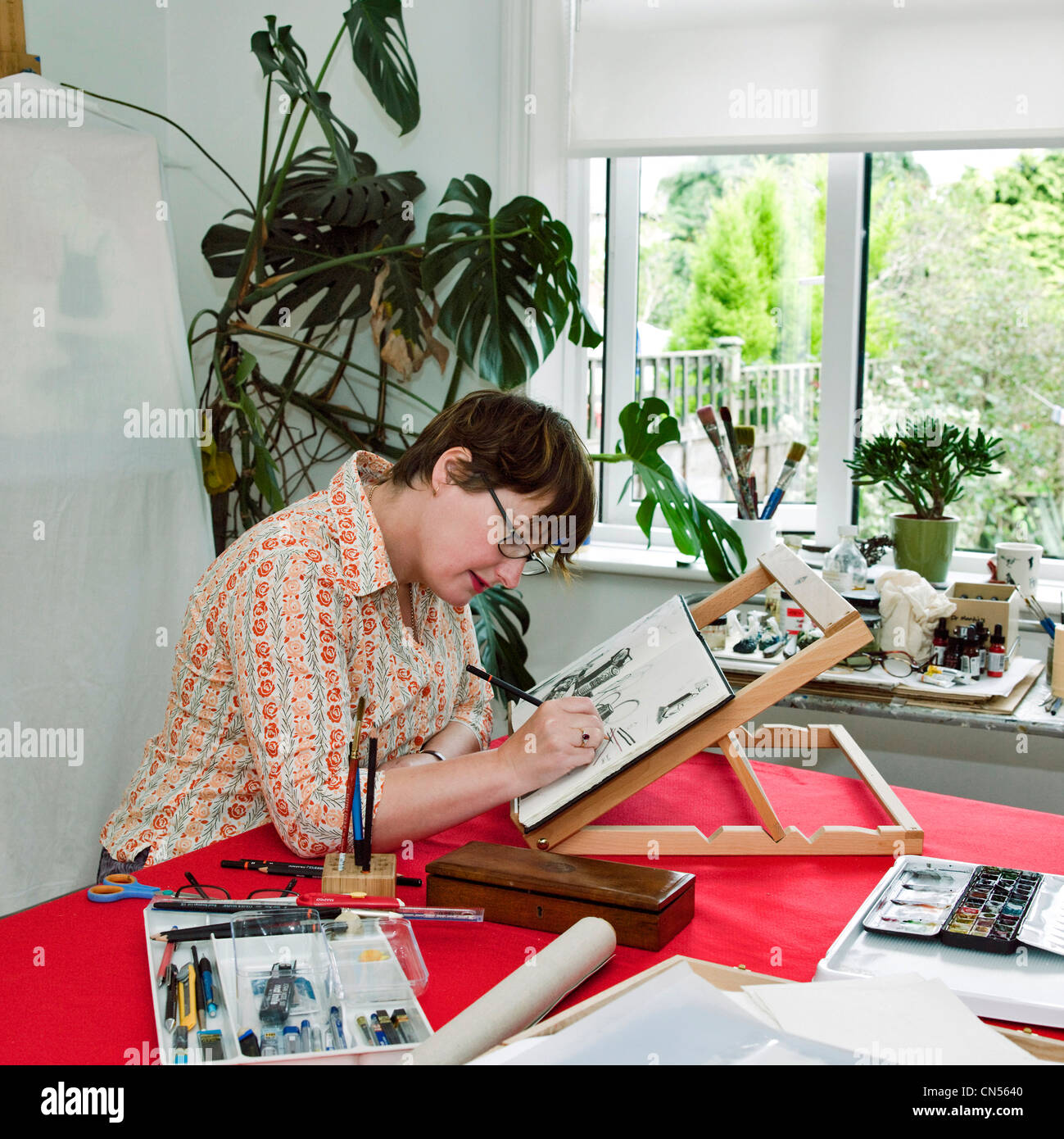 British Artist Julie Roberts working in her Carlisle studio, lives and works in Carlisle, England. Stock Photo