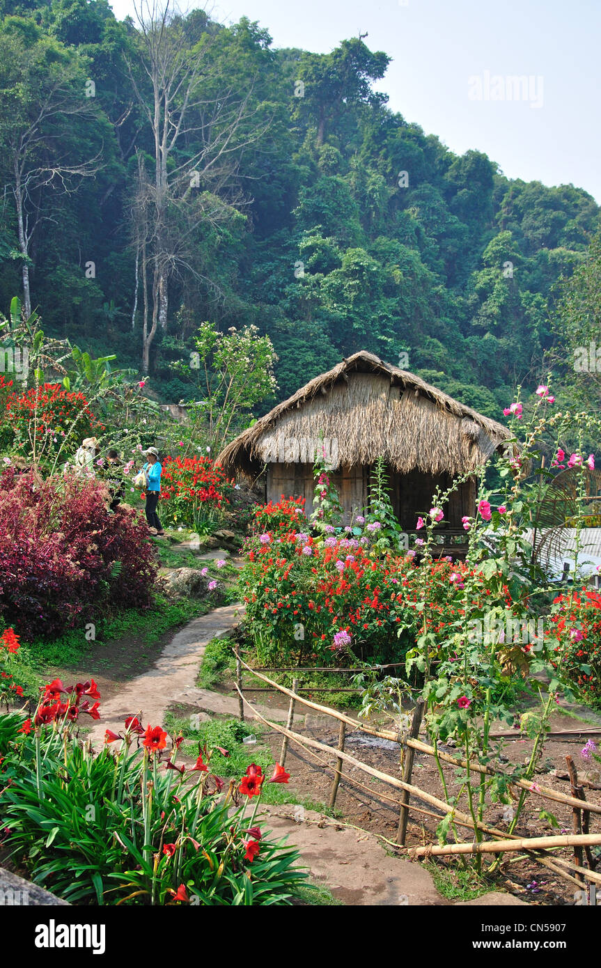 Traditional thatched Akha house in Hill tribes Village Museum and gardens, near Chiang Mai, Chiang Mai Province, Thailand Stock Photo