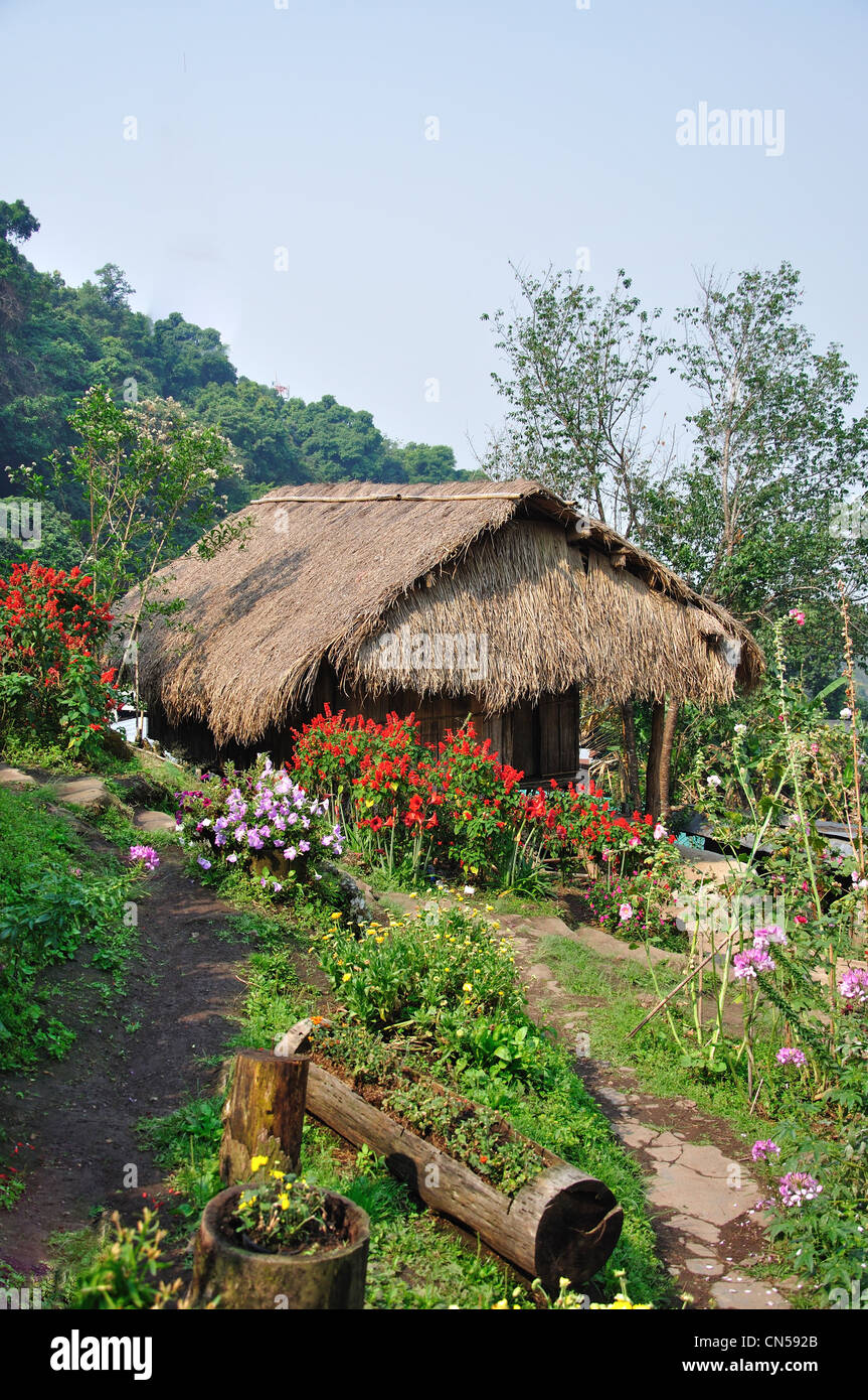 Traditional thatched Akha house in Hill tribes Village Museum and gardens, near Chiang Mai, Chiang Mai Province, Thailand Stock Photo