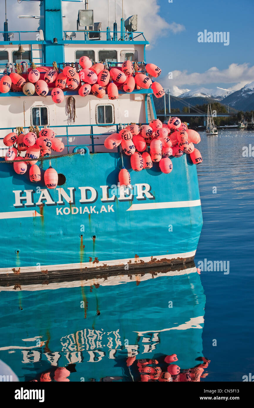 Colorful floats hanging stern of sac roe herring fishery tender docked in Sitka, Alaska. Stock Photo