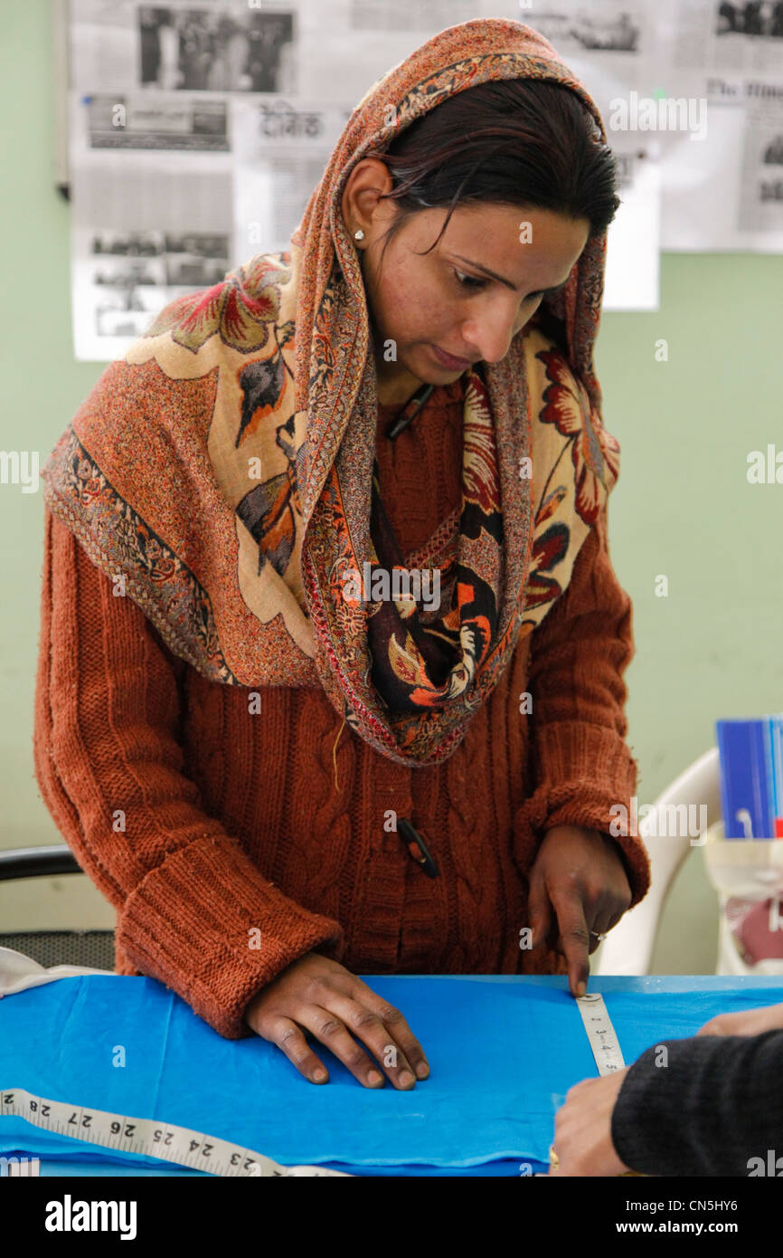 Dehradun, India. Muslim Indian Woman Measuring a Piece of Fabric. Stock Photo