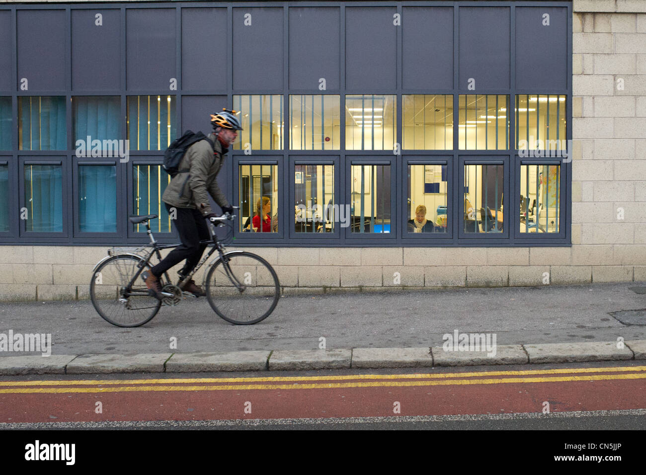 A cyclist riding on the pavement Stock Photo Alamy