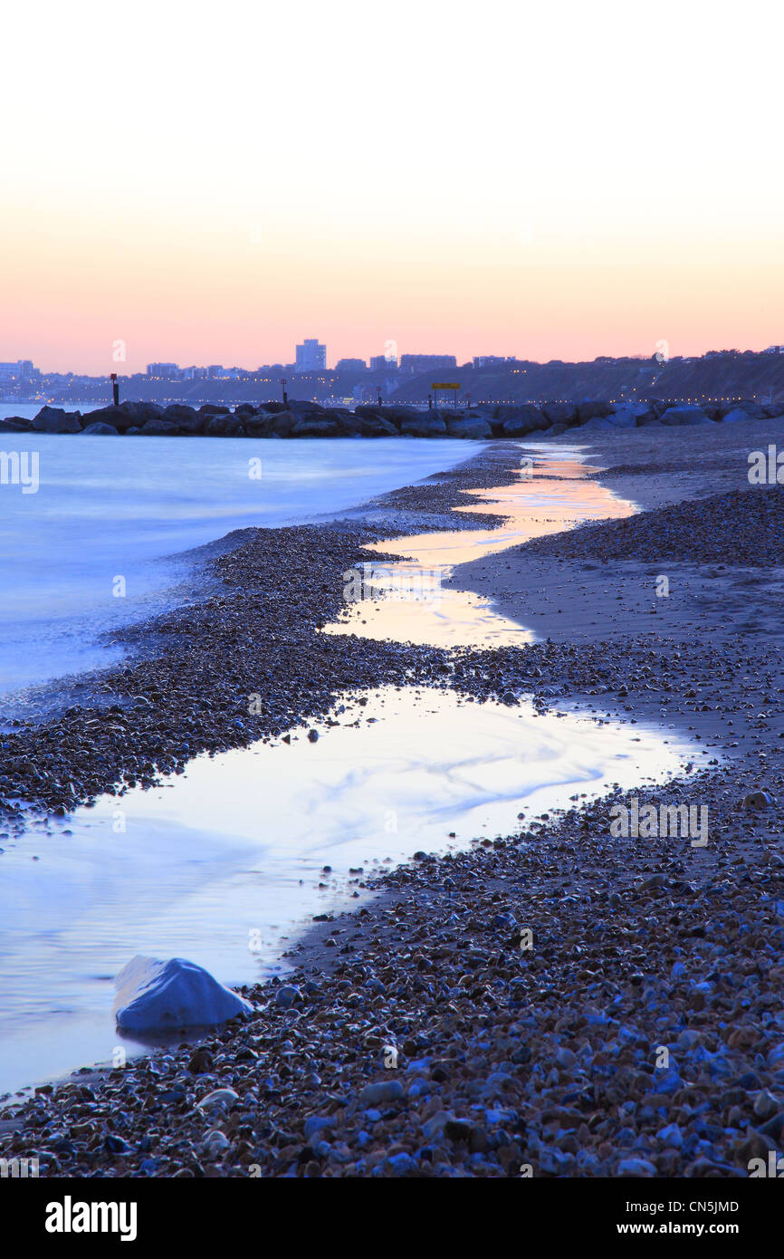 Tuckton beach at sunset with the view of Bournemouth, Dorset England Stock Photo