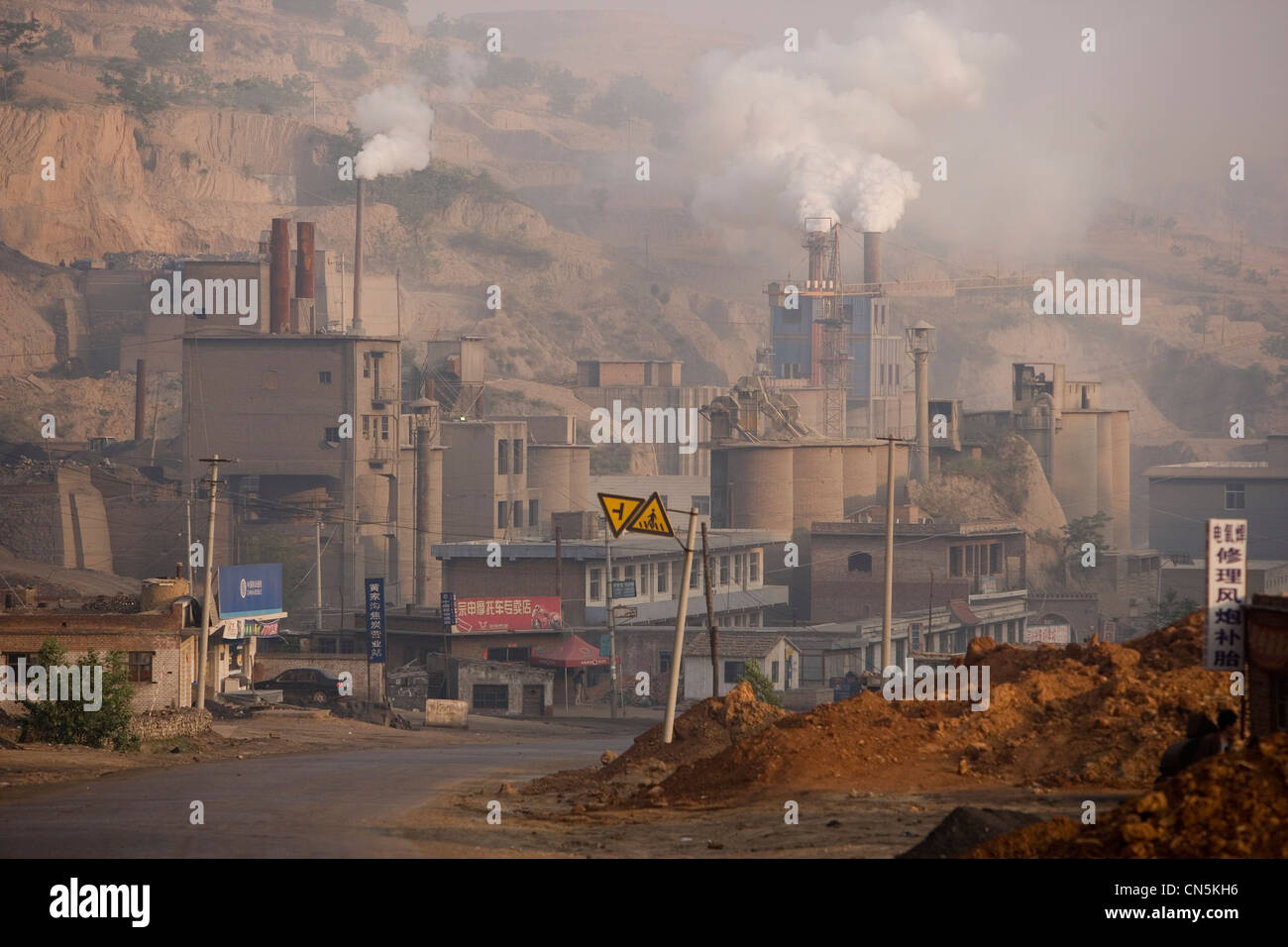 LINXIAN, HENAN PROVINCE, CHINA - JUNE 2006:  A cement factory, using old maufacturing methods, causes bad pollution Stock Photo