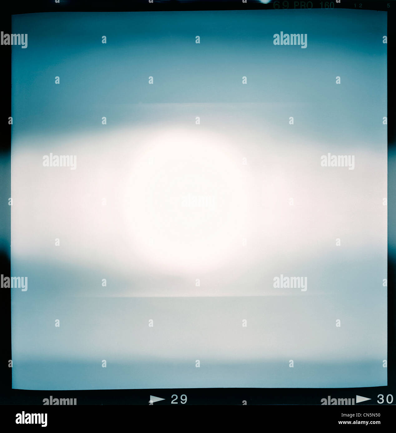 Blank medium format (6x6) color film frame with abstract filling containing lightleak in center, kind of a background Stock Photo