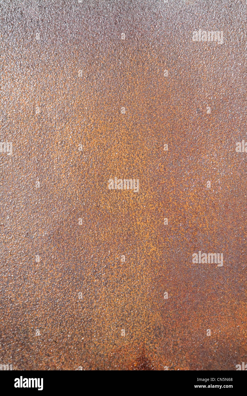 Wet rusty sheet of iron shined by the sun Stock Photo