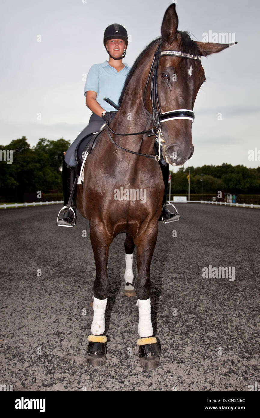 Dressage trainer on a horse in an outdoor arena, London, England, UK. Stock Photo