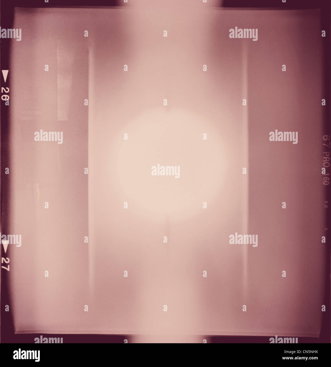 Blank medium format (6x6) color film frame with abstract filling containing lightleaked in the center Stock Photo