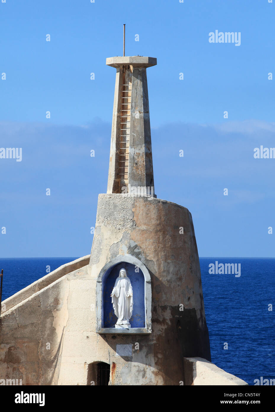 Statue of the Virgin Mary  at the corner of Cirkewwa harbour which is the terminal for the Malta Gozo ferry within Malta. Stock Photo