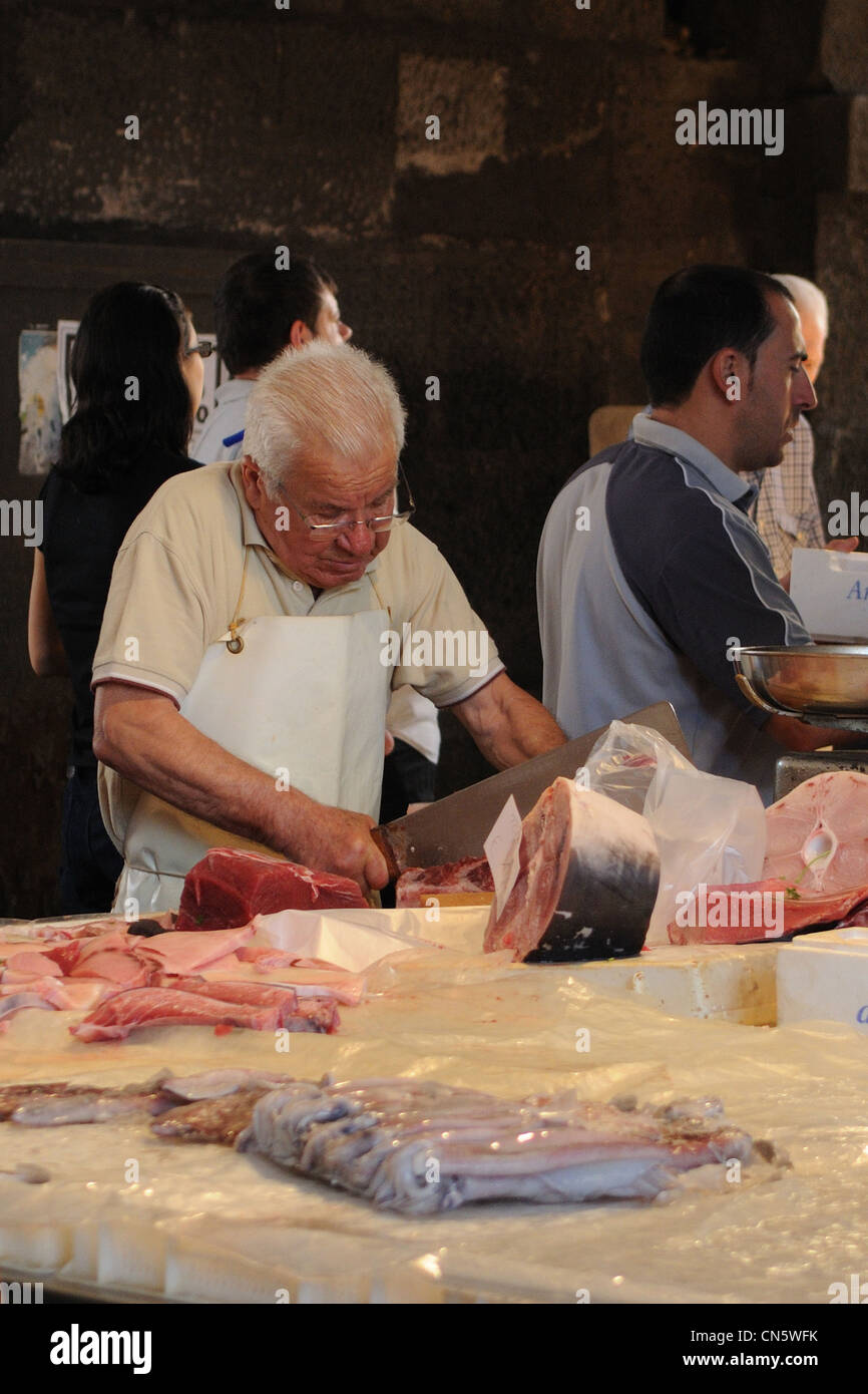 fishmonger while cutting swordfish, Catania, Italy Stock Photo