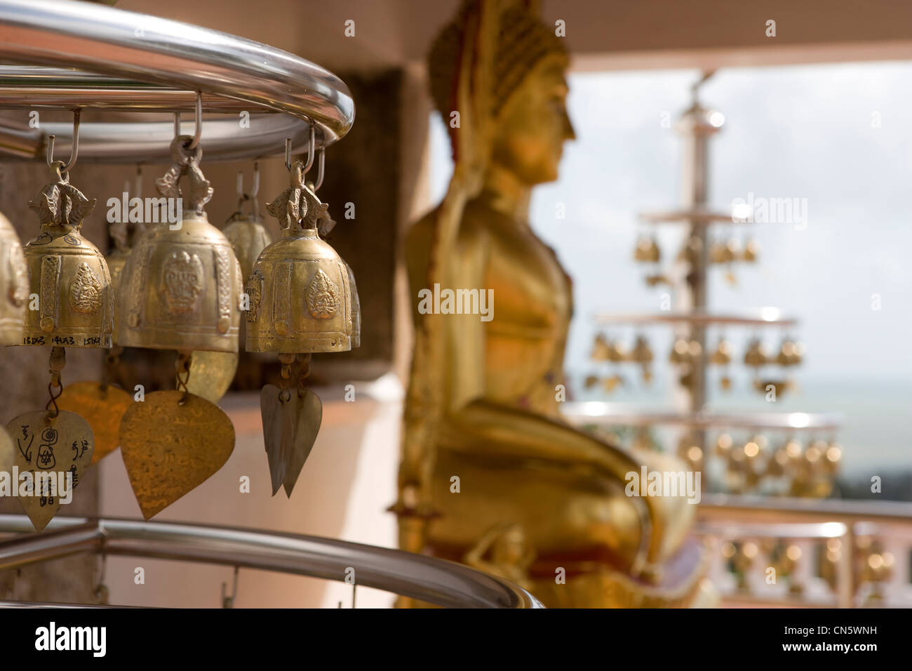 A Buddha statue and wind chimes at the ancient stupa and pagoda Phra Chedi Luang Stock Photo