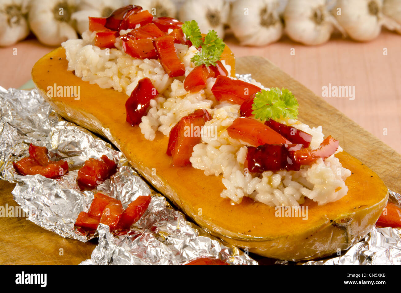 baked butternut stuffed with rice and red peppers Stock Photo