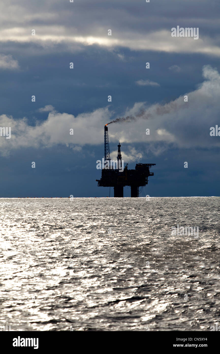 oil rig with dark gloomy sky Stock Photo