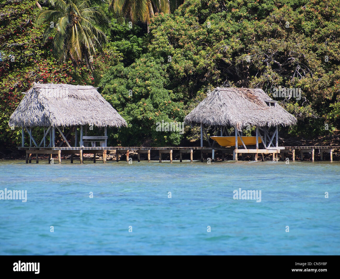 Boathouse and palapa over the sea with luxuriant tropical vegetation in the background Stock Photo