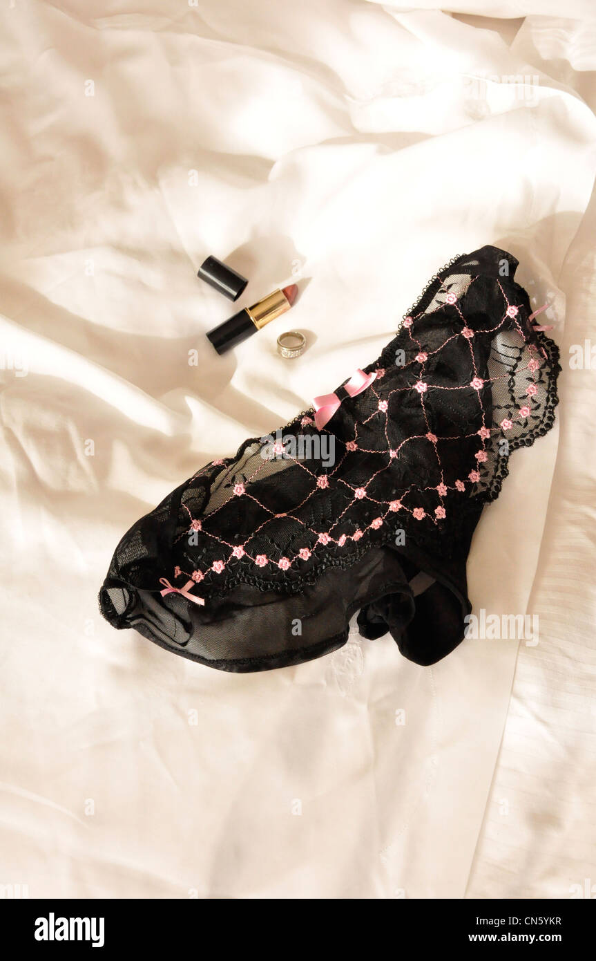Black & pink knickers, diamond ring, lipstick Stock Photo
