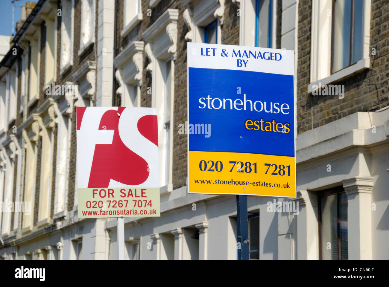 ‘ For Sale ‘ and ‘ Let By ‘ signs outside a group of terraced houses Stock Photo