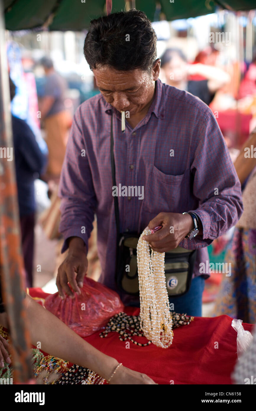 Stall-holder selling beads and strings of pearls, Central Market, Songkhla, Thailand, Jan 2008 Photo by Mike Goldwater Stock Photo