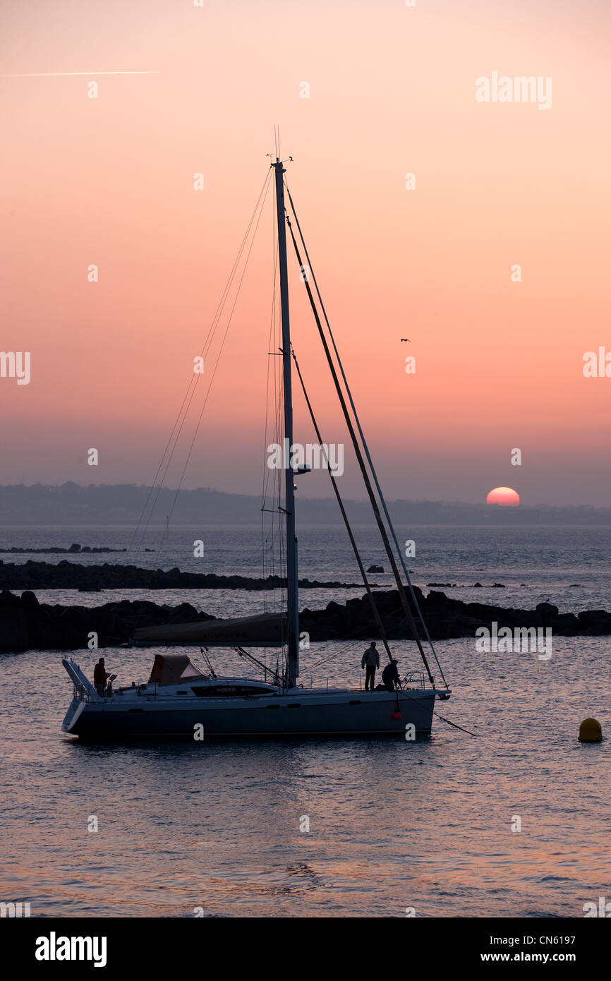United Kingdom, Channel Islands, Herm Island, sailboat at sunset Stock Photo