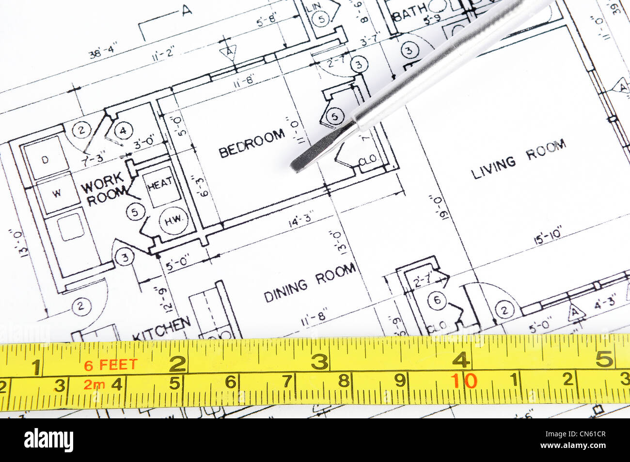 House blueprint with a measuring tape and a screwdriver on top of it Stock Photo