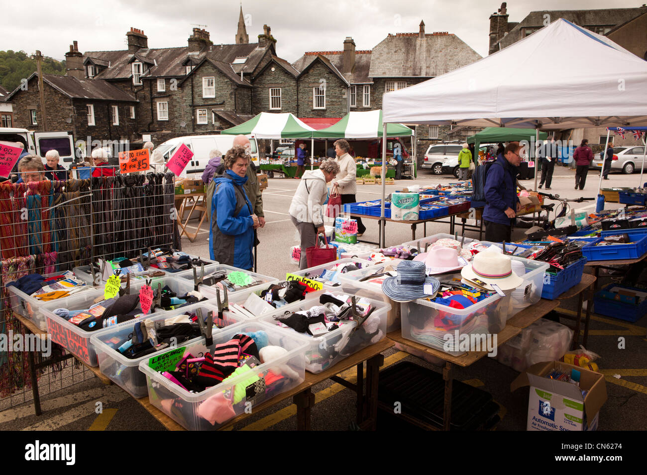 UK, Cumbria, Ambleside, King Street outdoor market, shoppers browsing at clothes stall Stock Photo