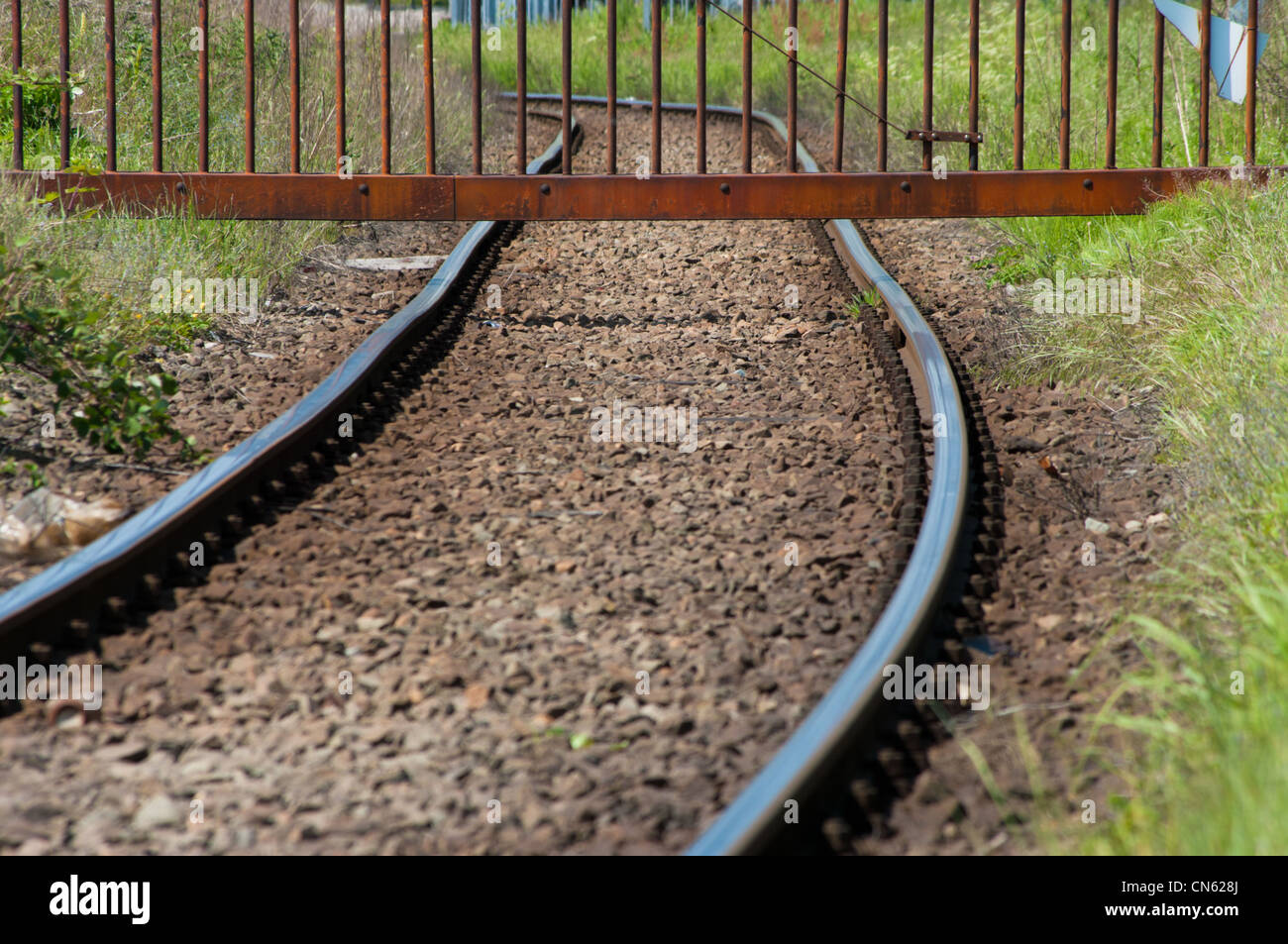 fence over a railroad to prevent entering an industrial area Stock Photo