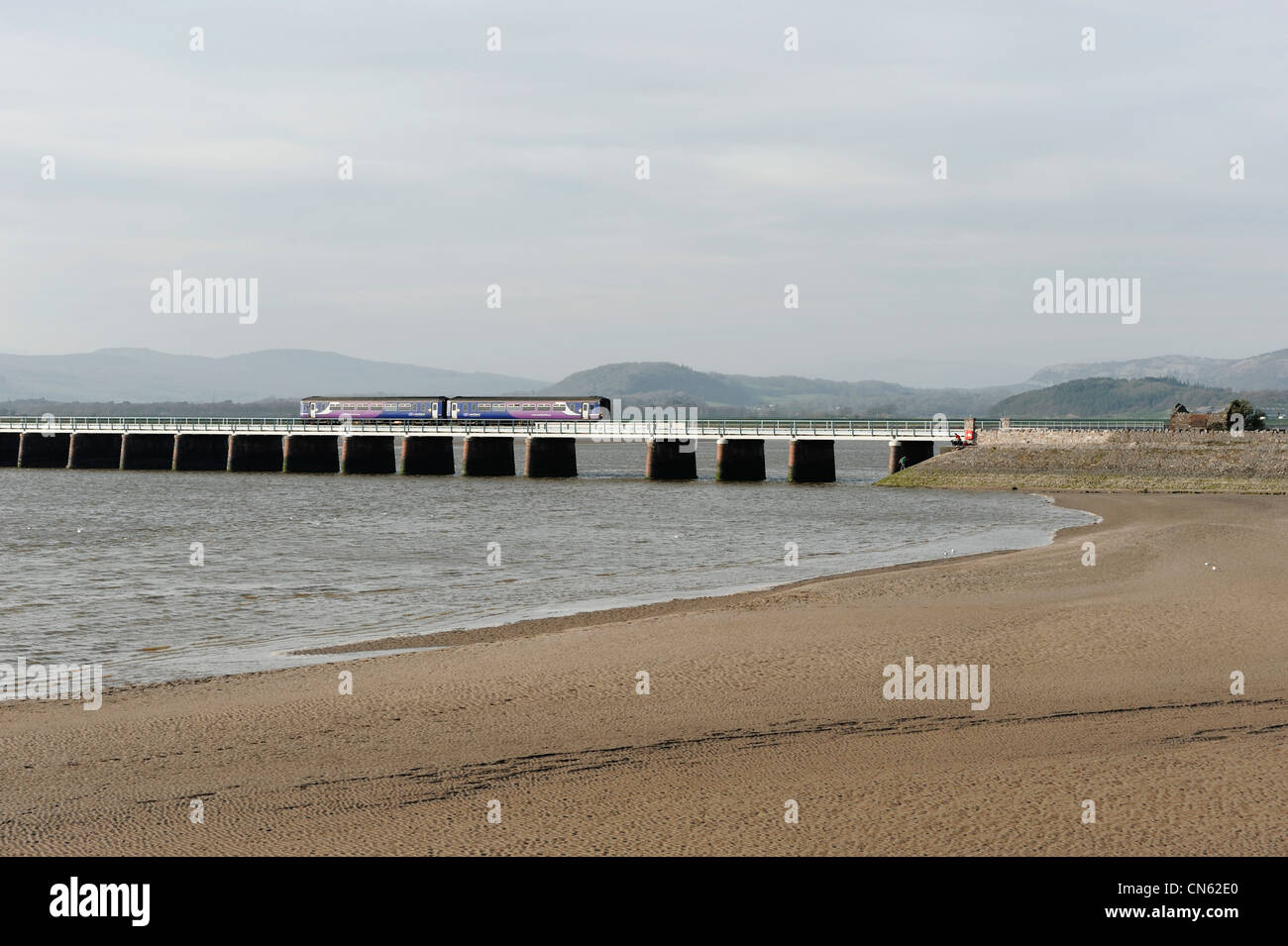 Train crossing the viaduct at Arnside Cumbria Stock Photo