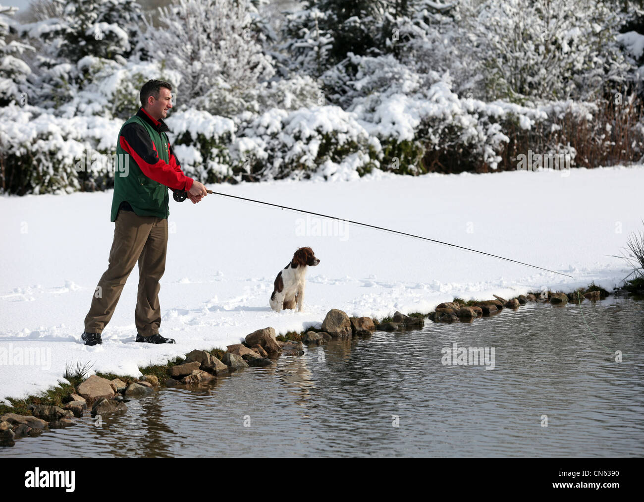 Man and his dog fishing at Lochter fishery near Oldmeldrum in Aberdeenshire, Scotland, UK Stock Photo