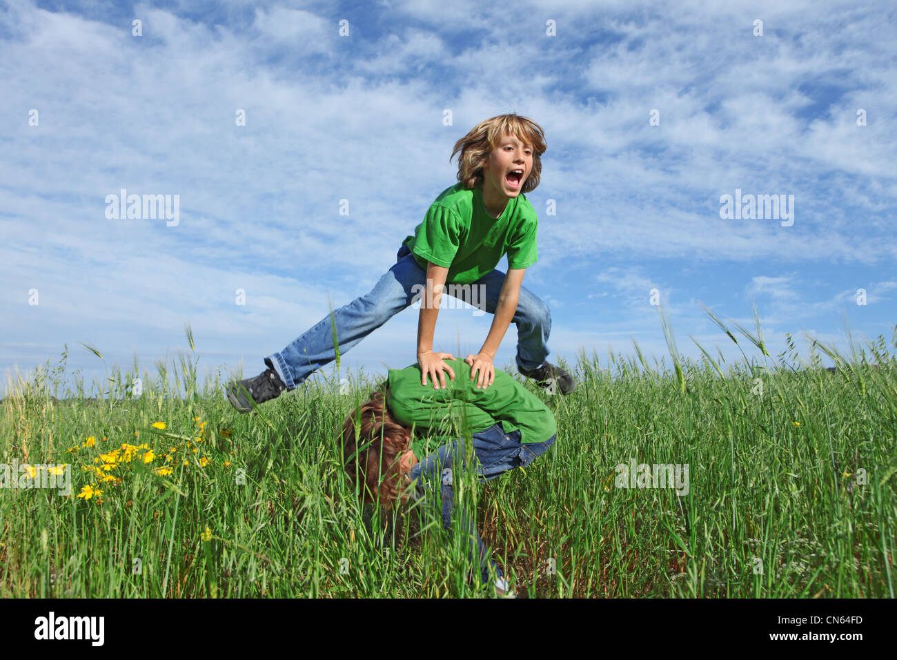 happy healthy kids playing leapfrog outdoors in summer Stock Photo