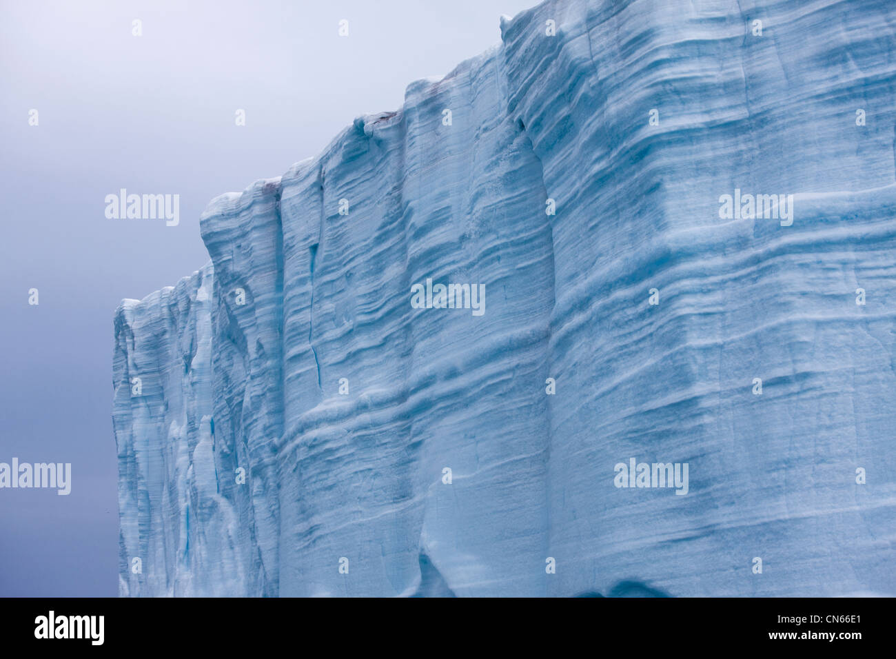 Norway, Svalbard, Nordaustlandet, Patterns in vertical ice face of Brasvellbreen Icefield on stormy summer morning Stock Photo