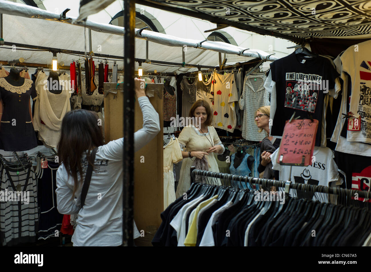 Shopper, tourist, buying cloths, and t-shirts in Camden Market, Camden Town, London, England Stock Photo