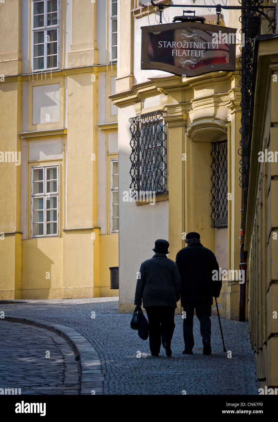 Old couple walking in Dominikánská Street, in the old town of Brno. Stock Photo