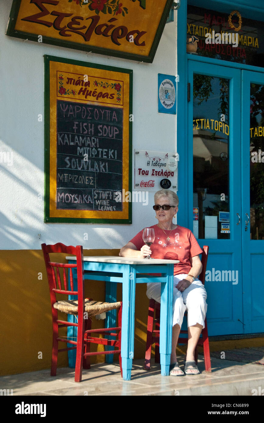 Tourist outside a Greek restaurant. Stock Photo