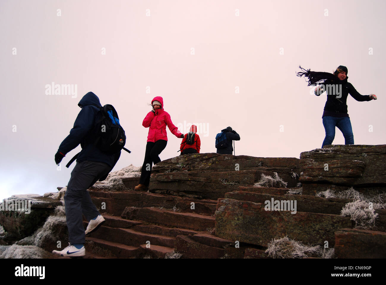 Scarves and trainers on the summit of a windy pen y fan number 3098 Stock Photo