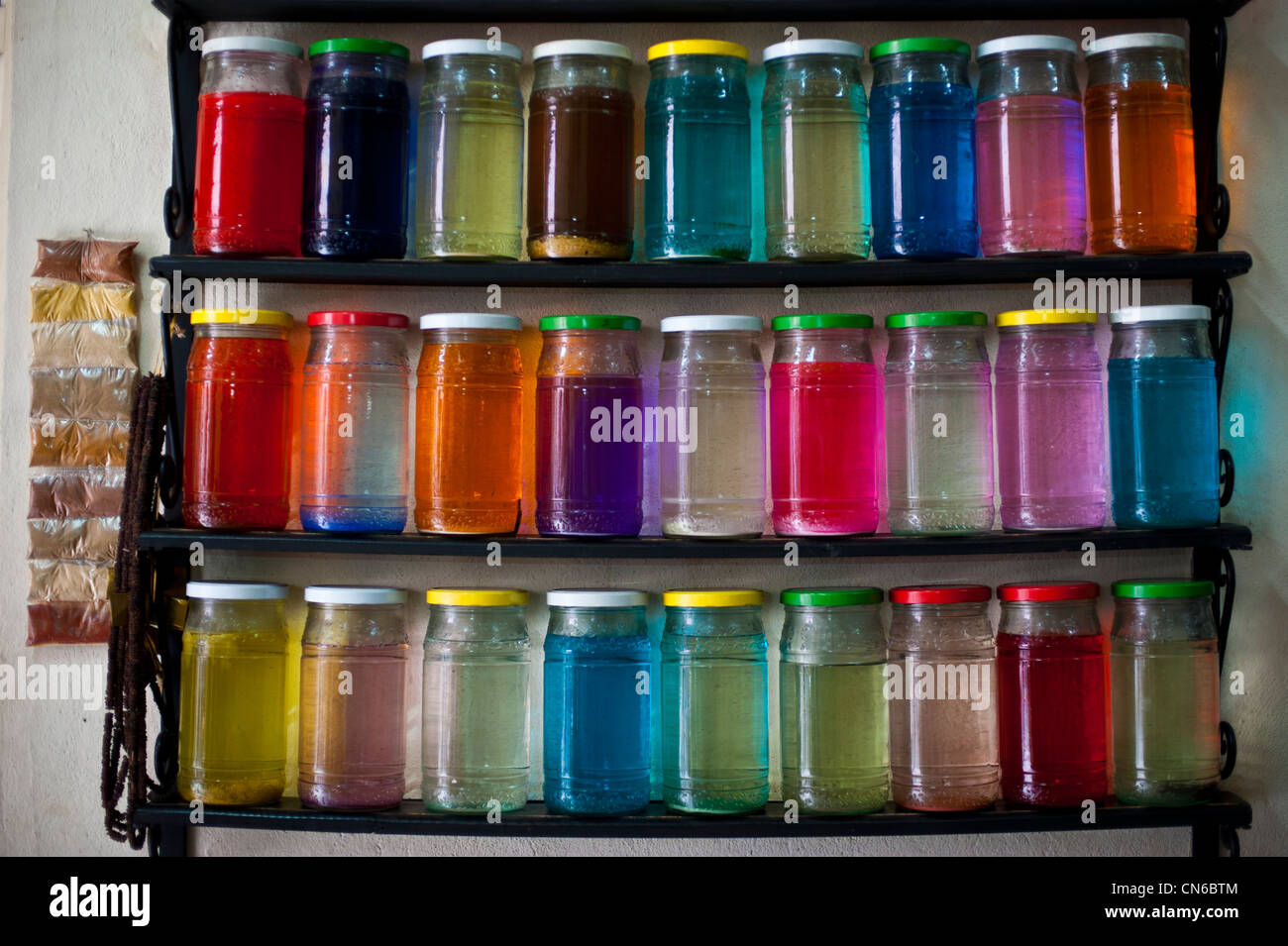 Glass Jars with colourful dyeing liquid. Marrakech, Morocco. Stock Photo