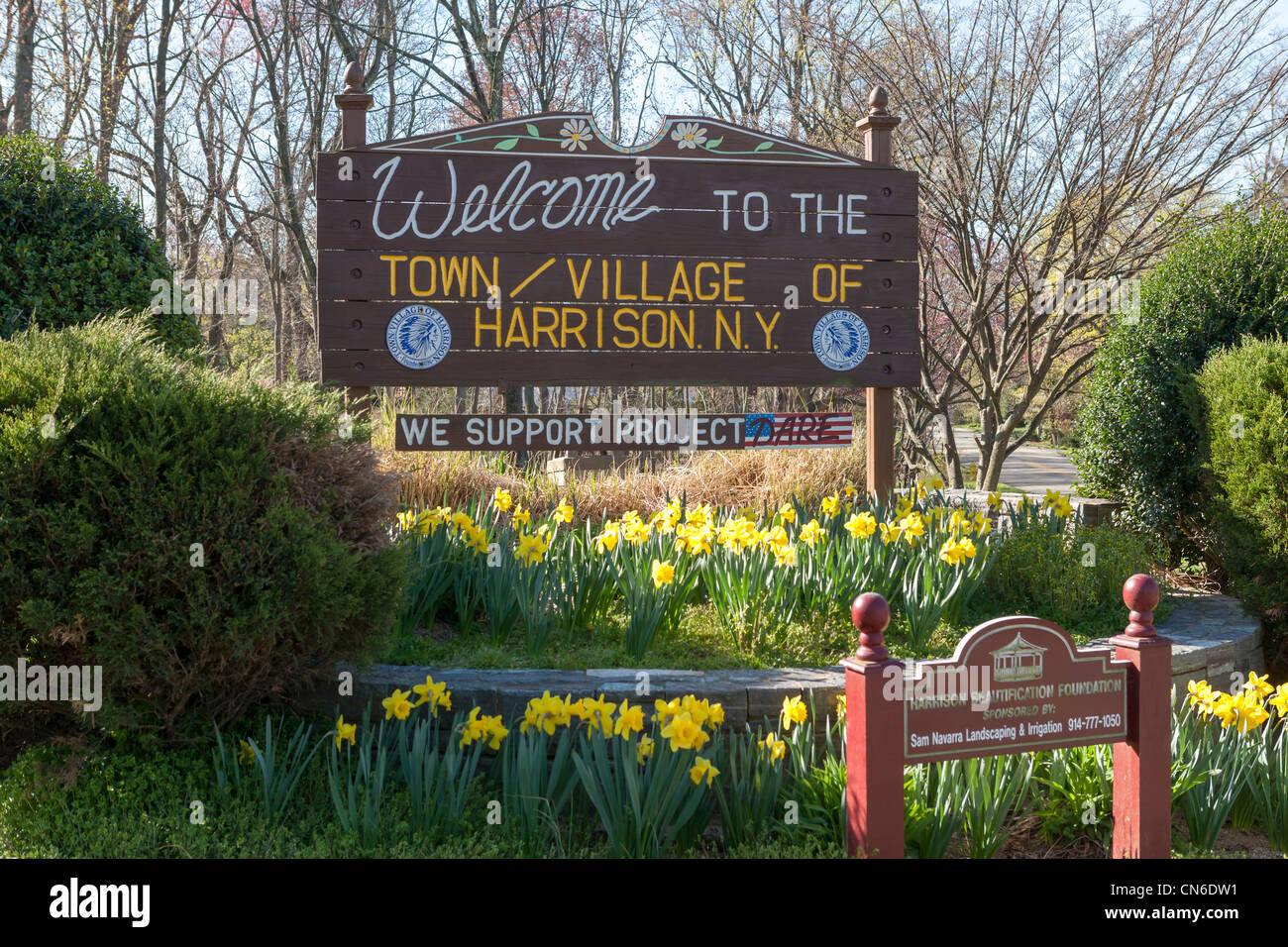 A sign welcomes visitors to the town / village of Harrison, New York Stock Photo